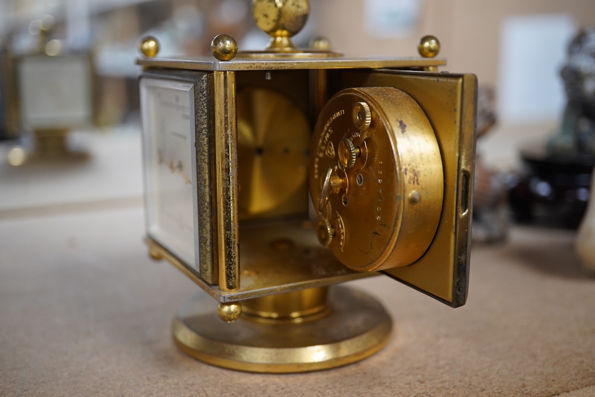 An Imhof brass combination clock, hydrometer, barometer and thermometer, 12cm high. Condition - fair